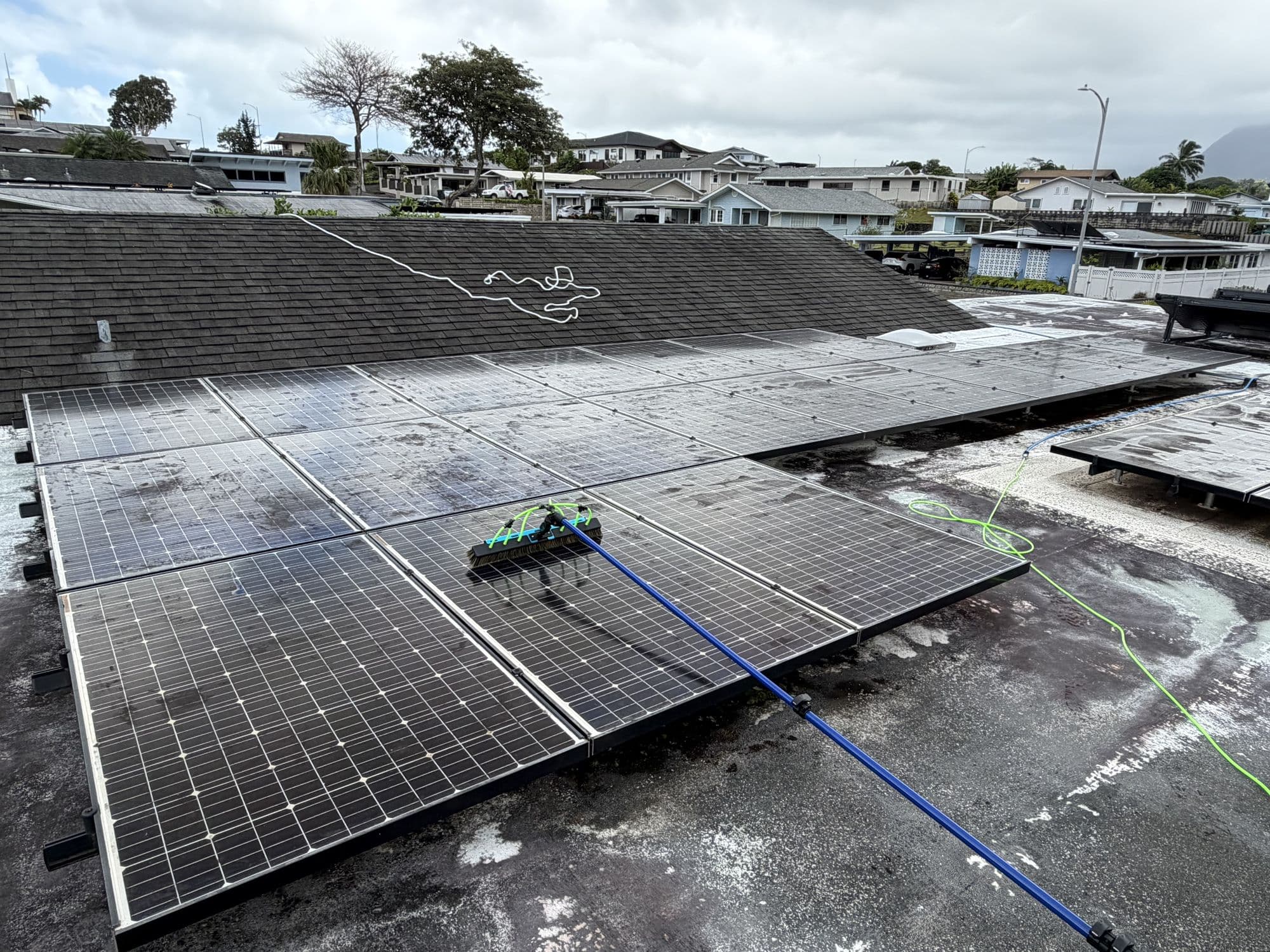 The rotating brush cleaning a dirty solar array