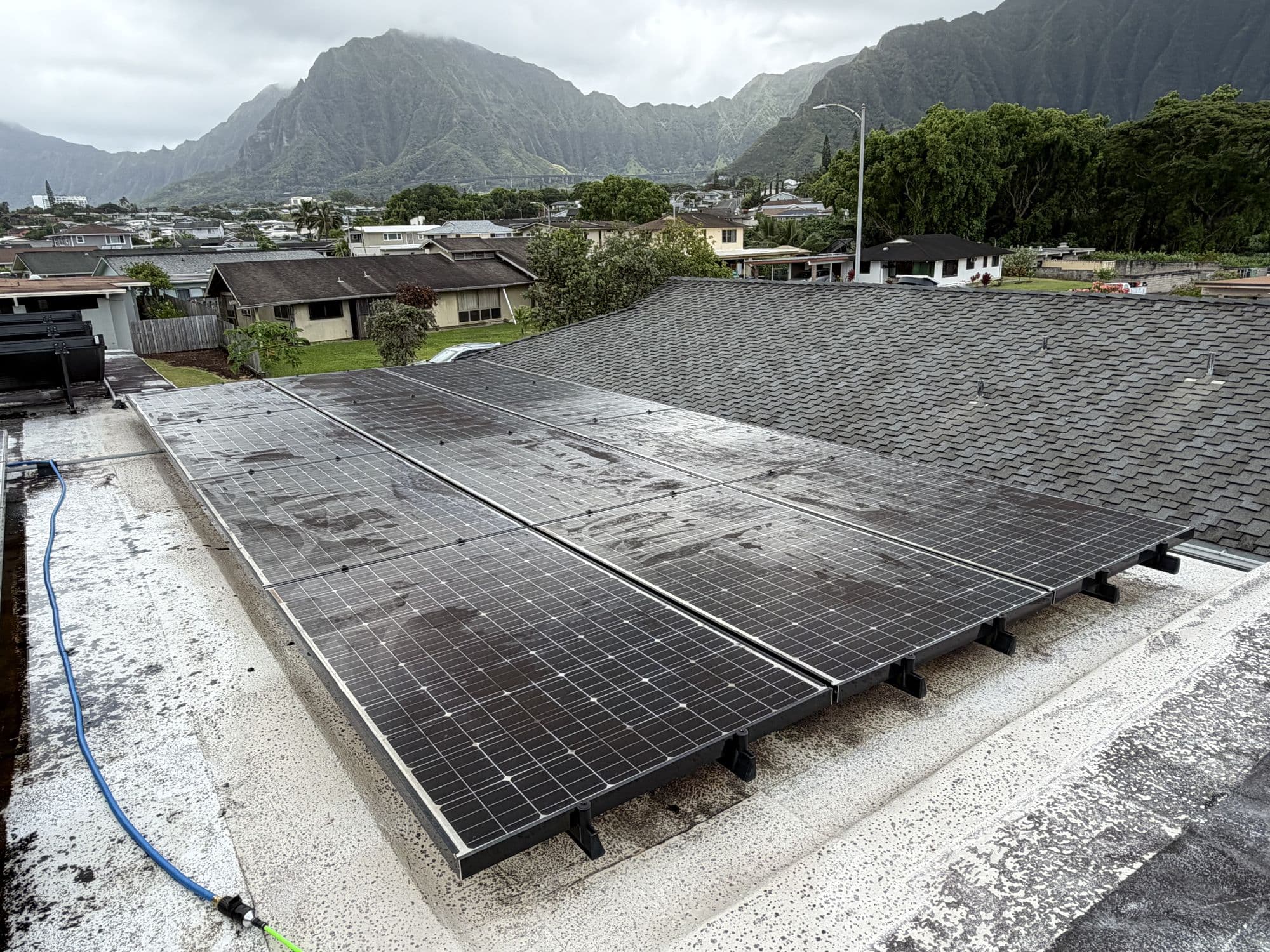 Dirty solar panels on a Kaneohe roof before cleaning